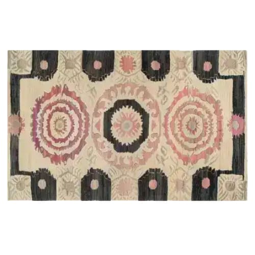 Harmony Circles Hand Tufted Area Rug featuring a vintage design with intricate circular patterns in soft pink and beige tones, ideal for a dining room or office. This wool rug adds a classic touch to any dining table setting.