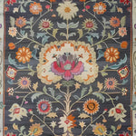 Detailed view of the Heirloom Petals Classic Hand Tufted Rug, showcasing a vibrant floral design in rich colors. This wool area rug is perfect for adding a vintage touch to your living room. The 8x10 size makes it an ideal large area rug for any space.