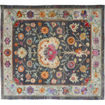 A beautifully intricate Heirloom Petals Classic Hand Tufted Area Rug, perfect for vintage or floral-themed living rooms. This 8x10 wool rug features a stunning array of colorful flowers set against a dark background, exuding a timeless charm. Ideal as a large area rug for adding warmth and elegance to any living room space.