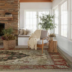Cozy living room with a fireplace, armchair, hand knotted persian rug, and decorative elements.
