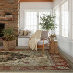 Cozy living room with a fireplace, armchair, hand knotted persian rug, and decorative elements.