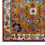 A detailed close-up of the Heritage Suzani Hand Tufted Wool Rug, showcasing its vibrant floral patterns in rich blue, pink, and white hues on a warm golden background. This wool area rug is perfect for enhancing living room spaces with its intricate design and luxurious texture, making it a standout piece among living room area rugs.