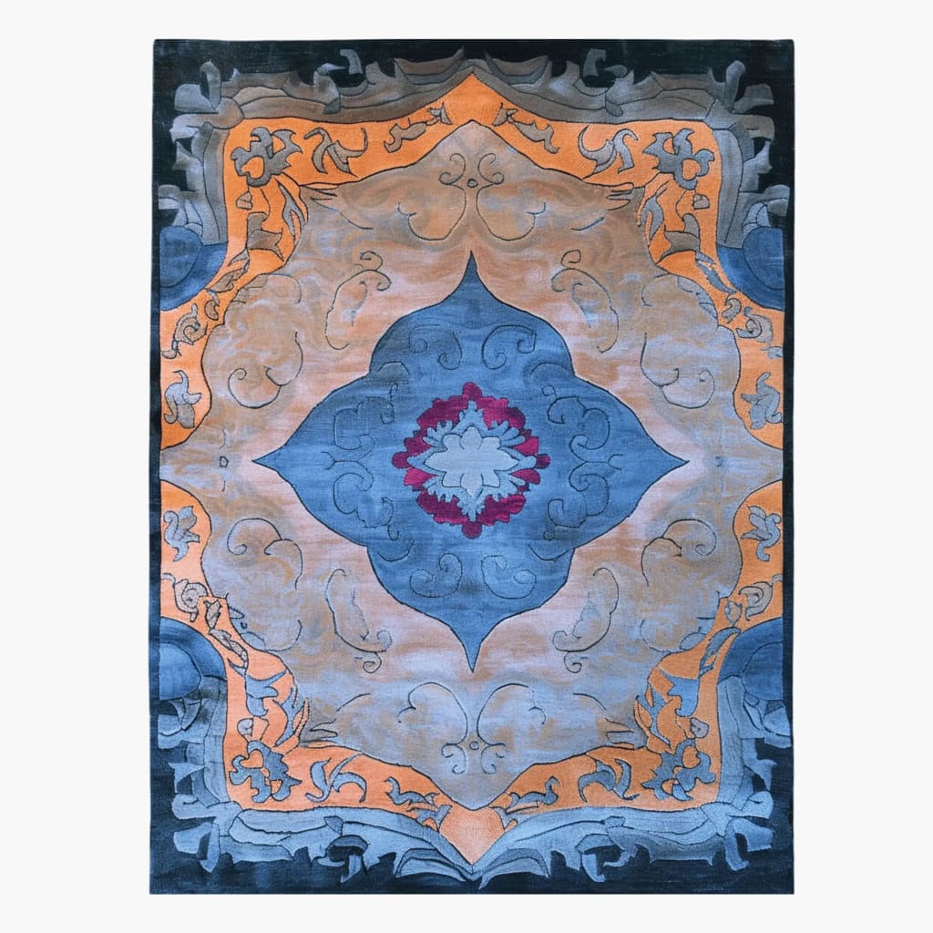 A beautifully designed Heritage Voyage Hand Tufted Area Rug featuring intricate patterns in shades of blue, orange, and gray. Perfect for adding a vintage touch to your dining room or living room. This wool rug is available in an 8x10 size, making it an ideal choice for large spaces.