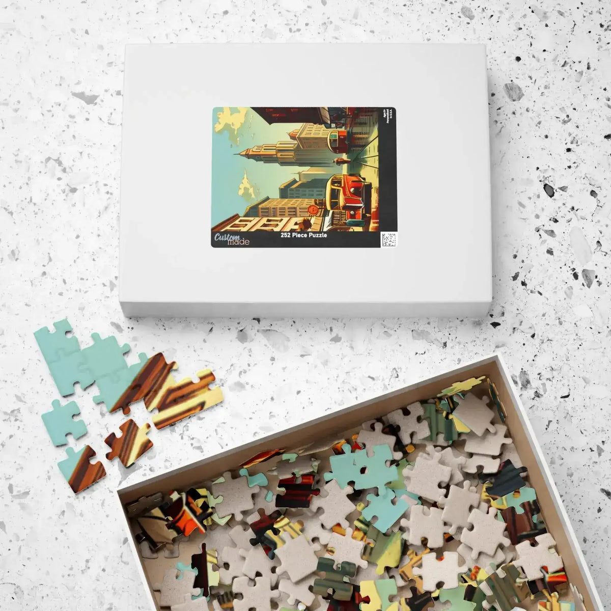 Historical City puzzle box with cityscape lid lying flat beside its open tray of pieces