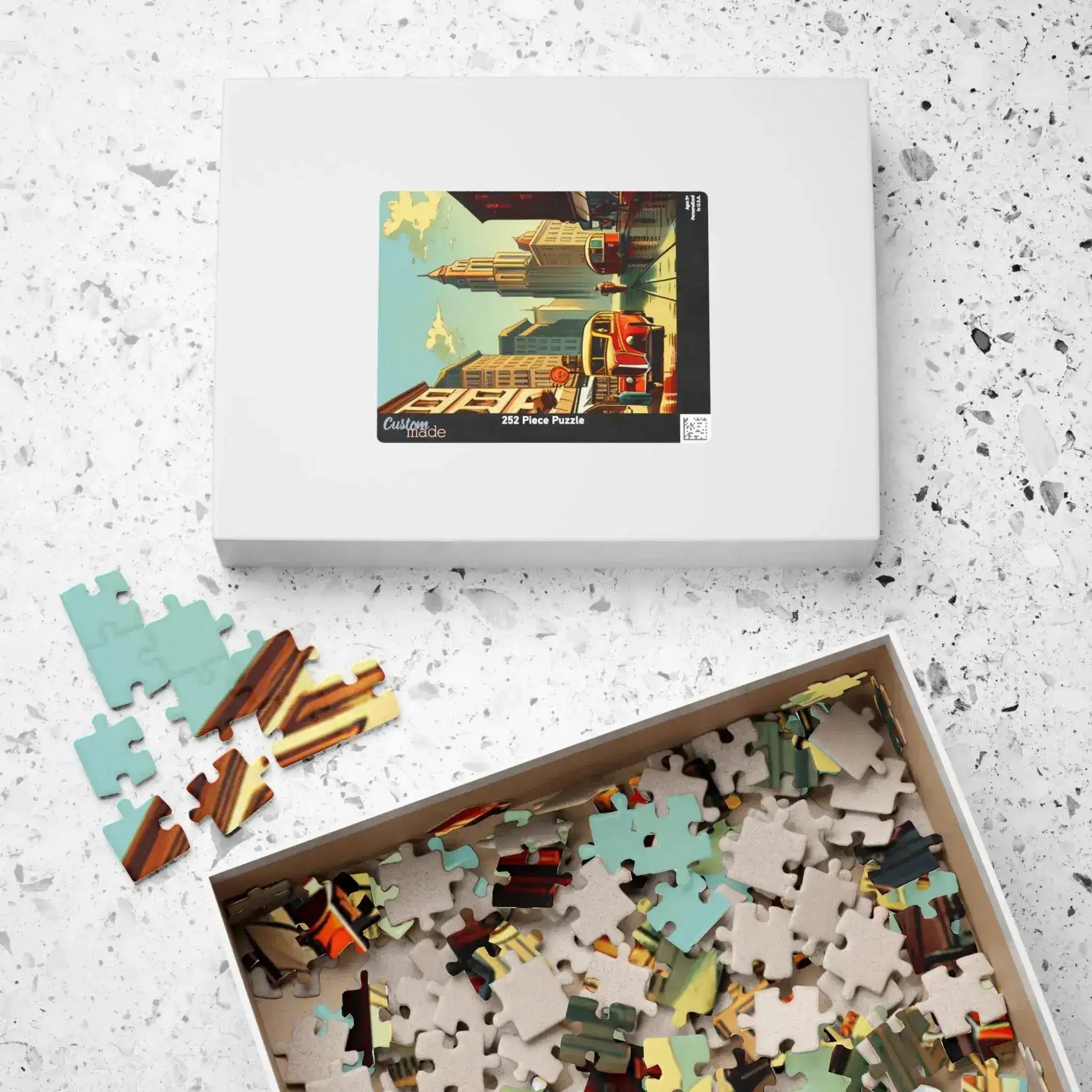 Historical City puzzle box with cityscape lid lying flat beside its open tray of pieces