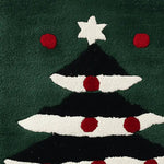 Close-up view of a hand tufted area rug featuring a stylized Christmas tree design with red and white accents. Perfect wool rug for adding a festive touch to your living room decor.