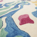 Close-up of a colorful patterned rug with abstract shapes.