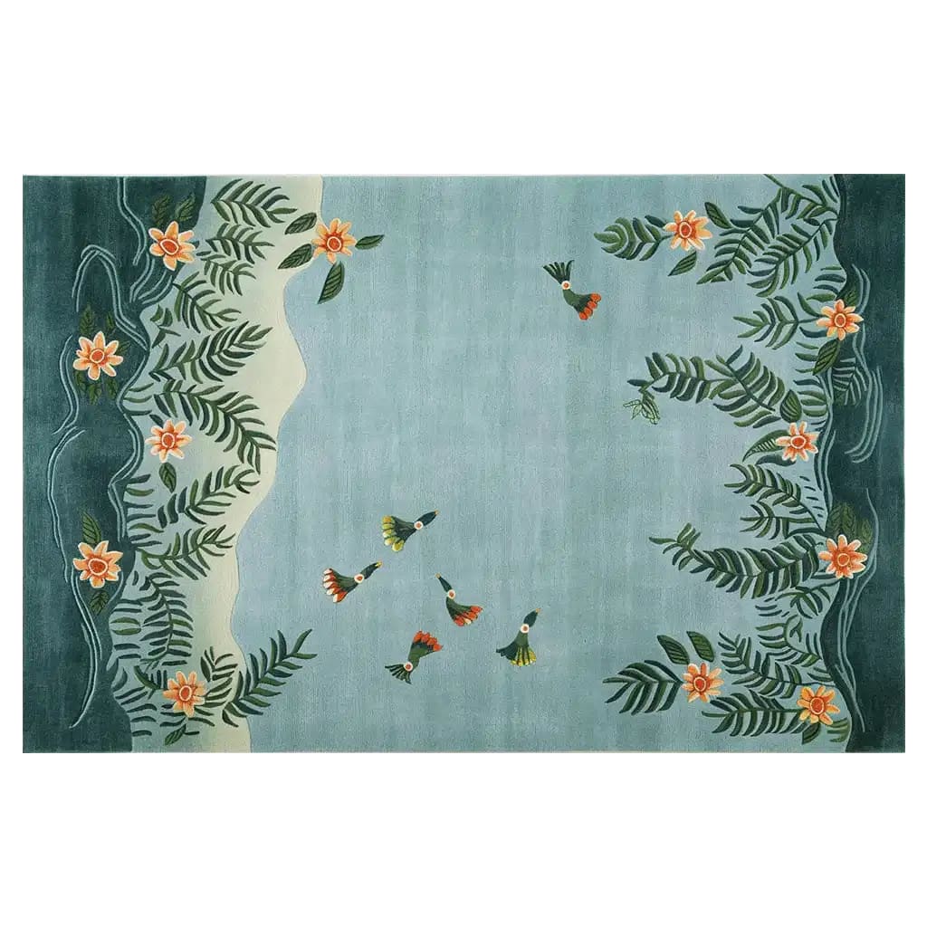 The Humming Haven Knotted Wool Rug, a large area rug perfect for living rooms, features a serene design with hummingbirds and floral patterns on a soft blue background, creating a tranquil atmosphere.