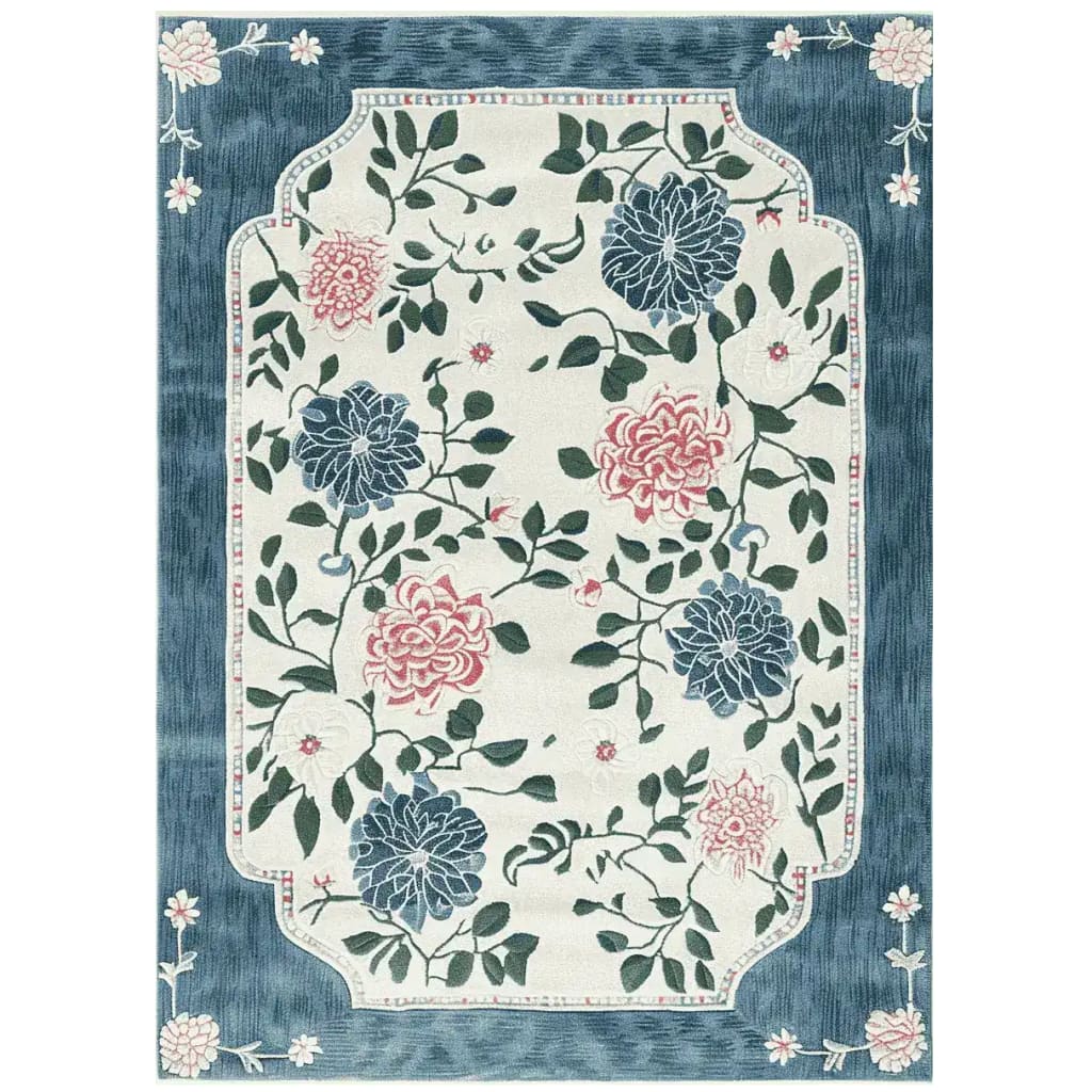 The Hushed Bloom Tangle Hand Tufted Rug is a stunning area rug featuring a vibrant floral design. This wool rug showcases intricate blue and pink blossoms intertwined with green leaves, set against a soft cream background. Perfect for large living rooms, this floral rug adds a touch of elegance and warmth, making it an ideal choice for area rugs in the living room.