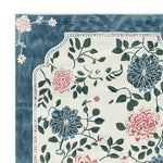 Close-up of the Hushed Bloom Tangle Hand Tufted Area Rug showcasing its intricate floral design. This wool rug features vibrant blue and pink flowers with lush green leaves, making it ideal for large living rooms seeking an elegant touch. Perfect for adding a splash of nature to your area rugs for living room collection.