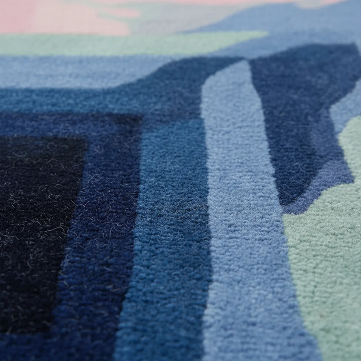 Close-up of a textured rug with blue and green patterns