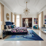 Luxurious bedroom with a blue rug, colorful bedding, and elegant decor.