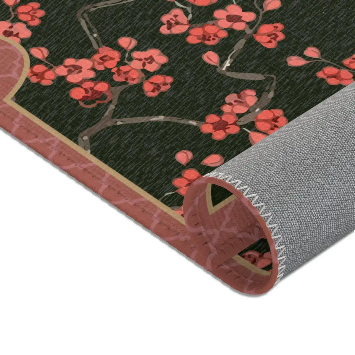 Imperial arch bloom rug rolled at corner showing coral blossoms, pink border and grey backing