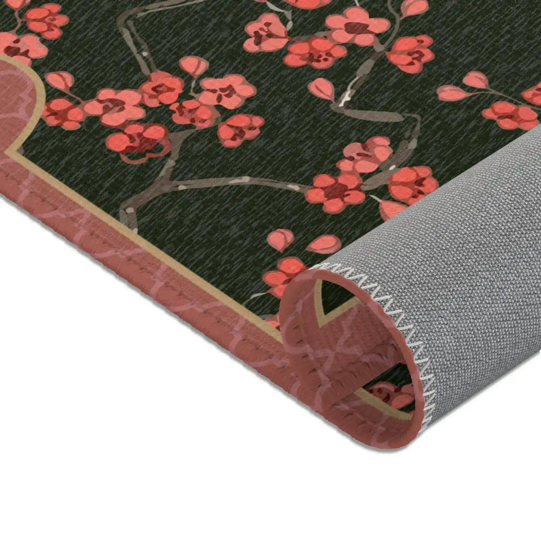 Imperial arch bloom rug rolled at corner showing coral blossoms, pink border and grey backing