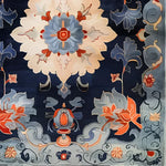 Elegant vintage wool rug with an intricate floral design in rich blues, reds, and creams, perfect as a large area rug for offices or living rooms. This hand-tufted piece combines classic charm with modern aesthetics, making it an ideal choice for those seeking stylish rugs for office spaces.