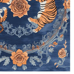 This beautiful area rug features a vibrant design with orange tigers and floral patterns against a deep blue background. Perfect for adding a vintage touch to your living room, this hand-tufted wool rug combines elegance with durability.