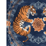 A vibrant area rug featuring a striking design of two tigers surrounded by intricate floral patterns. This wool rug showcases a rich blue background with orange and black tiger motifs, complemented by detailed rose and vine accents. Perfect for adding a vintage touch to your living room decor, this floral rug combines elegance with a bold statement.