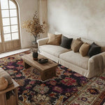 A beautifully styled living room features the Imperial Jewel Hand Knotted Area Rug, a square rug with vintage floral patterns. This wool rug adds a touch of elegance to the room, complementing the beige sofa and wooden coffee table. Perfect for dining room carpets or living room Persian rugs.