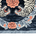Close-up view of the Imperial Roar Hand Tufted Rug showcasing its vibrant design. The area rug features bold floral patterns and roaring tiger motifs, combining vintage and abstract elements. This wool rug is ideal for living room settings, available in an 8x10 size, perfect for adding a touch of elegance and creativity to your space.
