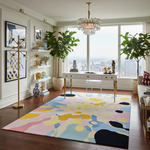 Modern living room with a colorful abstract rug, white desk, and large windows.