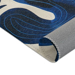 Indigo Desert Dreams rug corner close-up fold showing indigo cactus spiral motif and grey backing texture detail