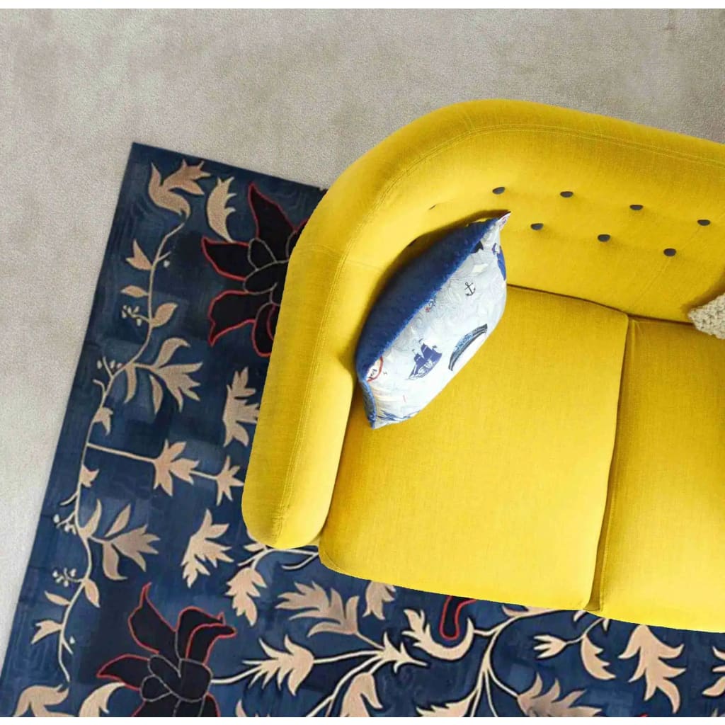 A vibrant and elegant area rug with a floral design in rich indigo hues, perfectly complementing a bright yellow sofa. This hand-tufted wool rug adds a vintage charm to the dining room, ideal for formal dining room settings.