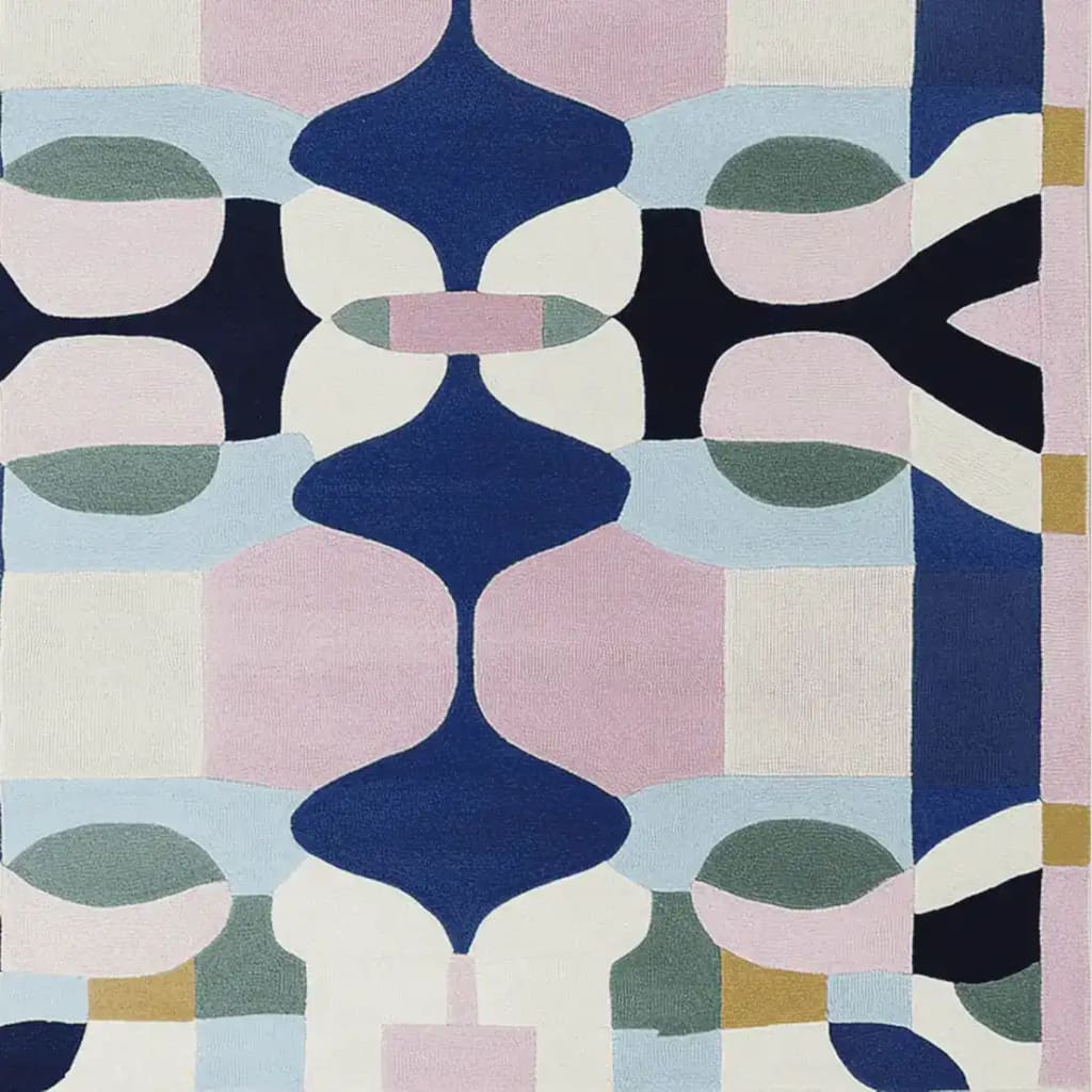 Top view of the Infinite Symmetry Hand Tufted Area Rug featuring a contemporary abstract design with bold colors like blue, pink, and white. This wool rug is perfect for adding a modern touch to your living room. Ideal for spaces needing an 8x10 living room rug.