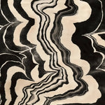 Stylish contemporary area rug featuring an abstract design in black and beige tones, perfect for dining room or living room settings. This wool rug, measuring 8x10, adds a touch of elegance to any space, serving as an ideal dining table rug or a standout piece among living room rugs.