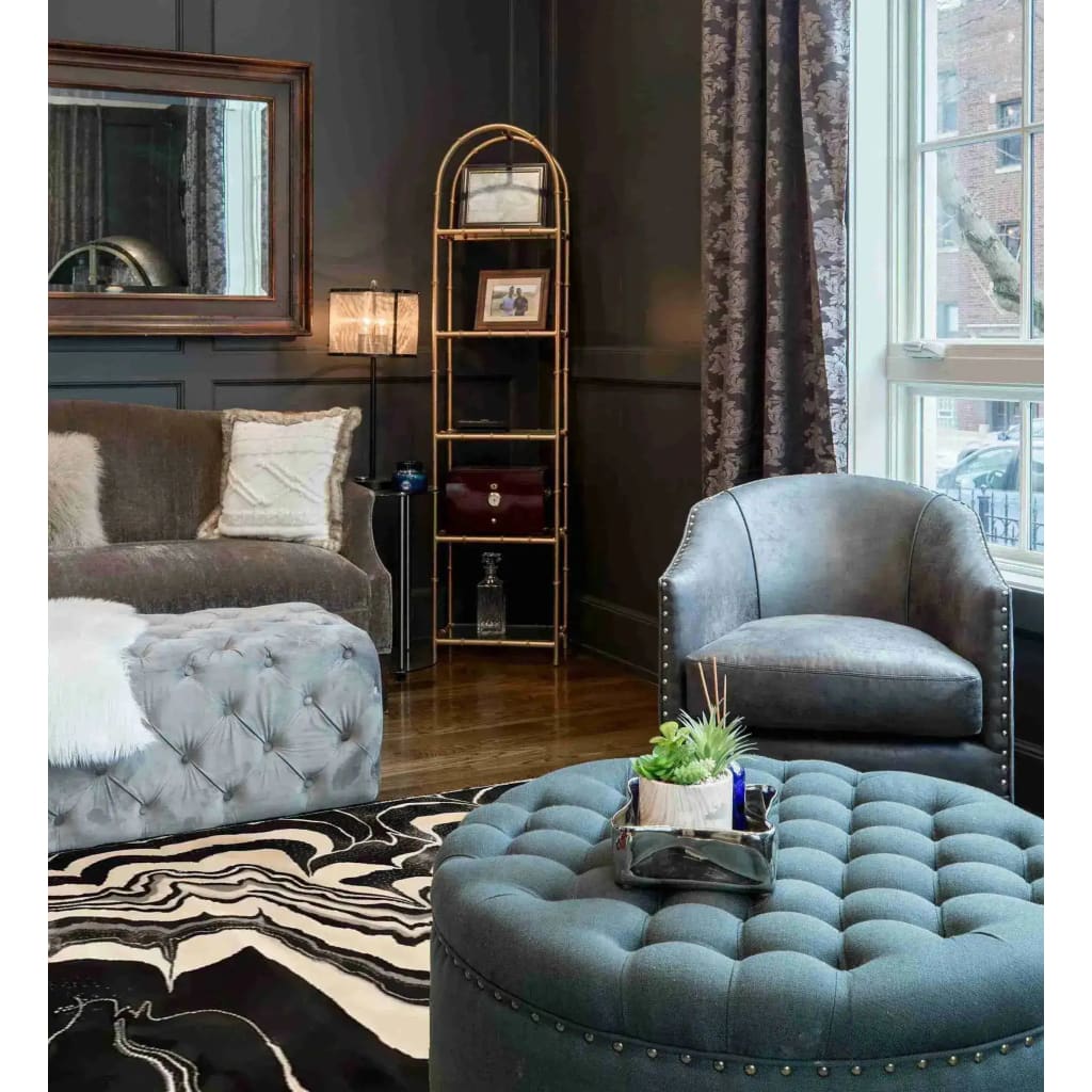 A stylish living room featuring the Ink Drift Hand Tufted Area Rug, perfect for dining room or living room settings. The rug's contemporary design in black and white waves adds a modern touch, complementing the plush grey furniture and elegant decor. Ideal as an 8x10 wool rug for a cozy and sophisticated ambiance.