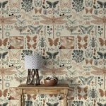 Vintage insect garden wallpaper detailing butterflies and dragonflies with script labels behind a rustic console table