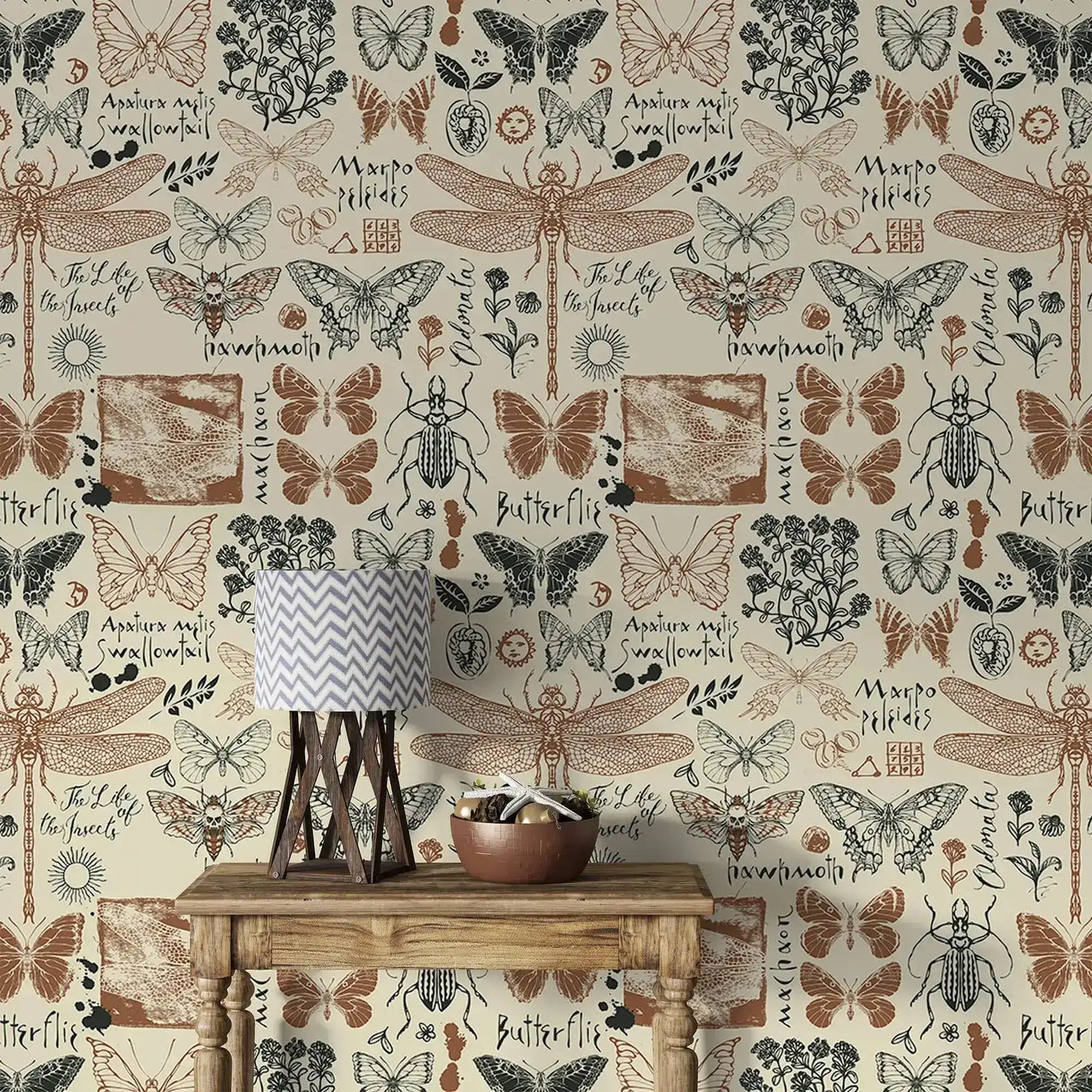 Vintage insect garden wallpaper detailing butterflies and dragonflies with script labels behind a rustic console table