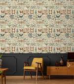 Insect garden wallpaper showing butterflies, beetles and dragonflies on cream above charcoal panelling in a retro room