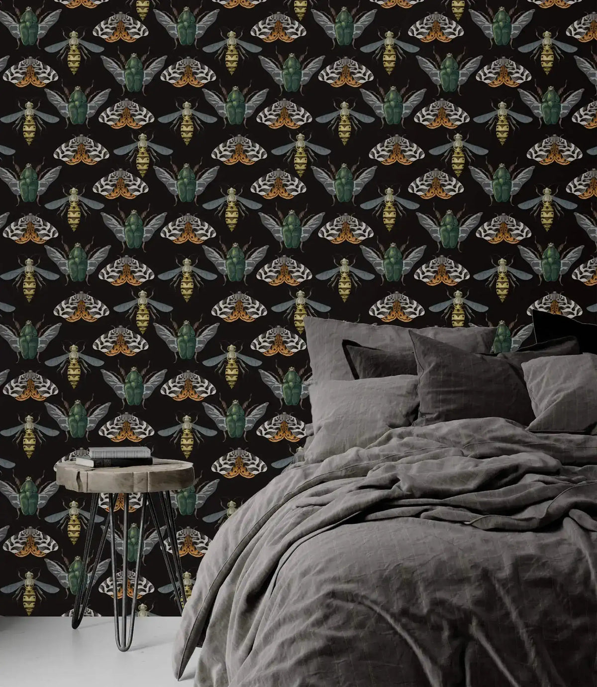 Insect Harmony Wallpaper as bedroom feature wall with gray linen bed; green beetles and moths on dark background