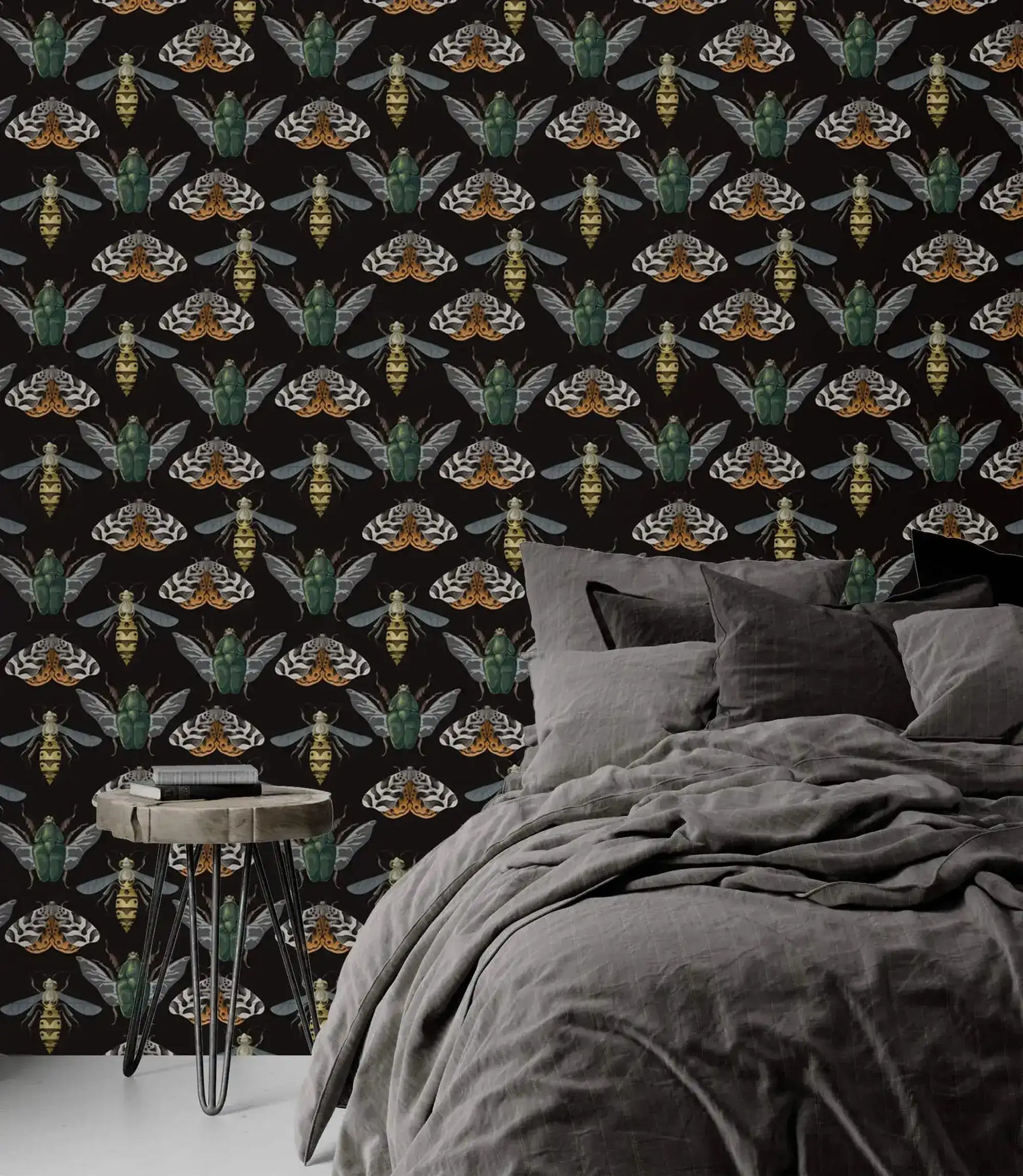 Insect Harmony Wallpaper as bedroom feature wall with gray linen bed; green beetles and moths on dark background