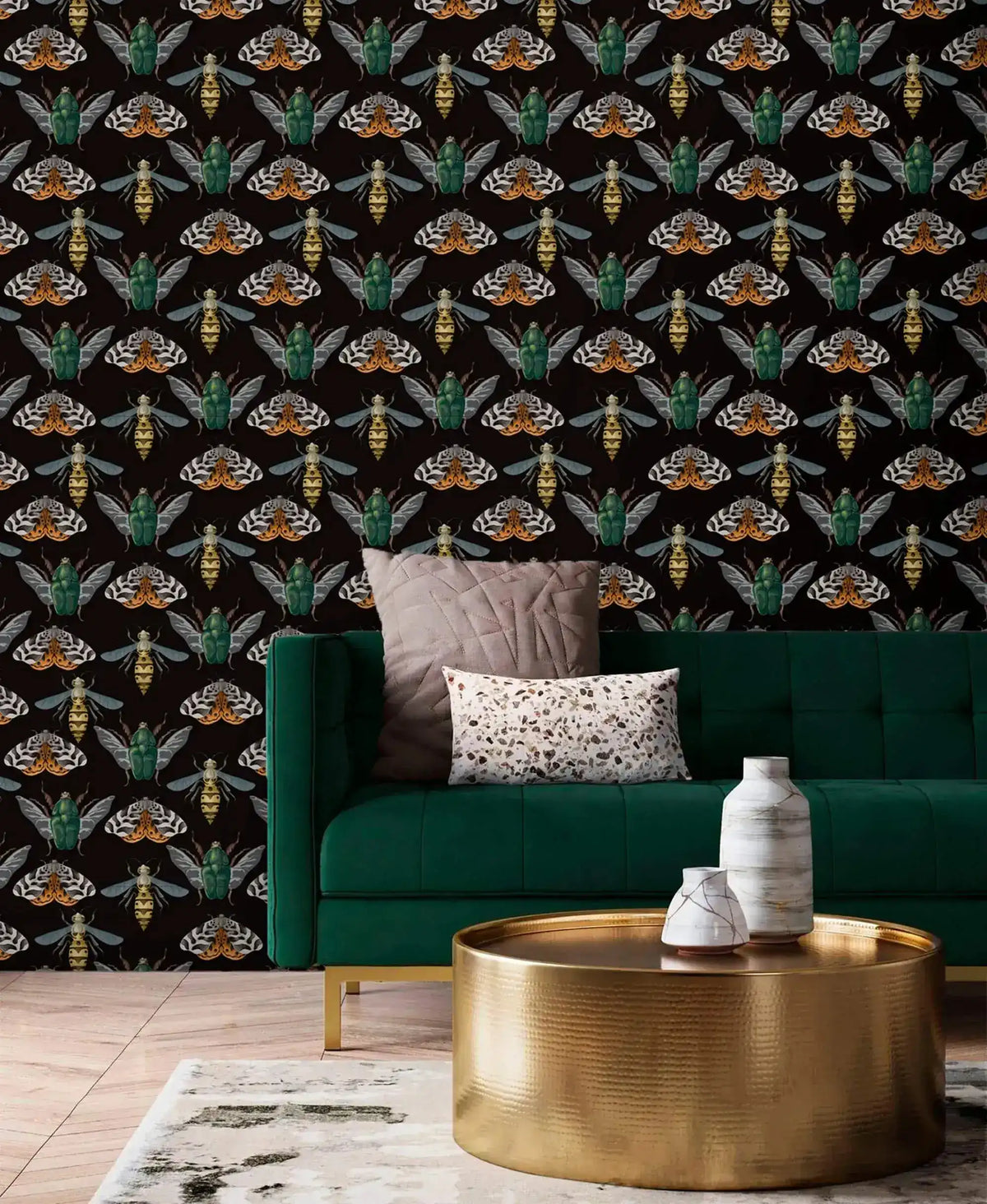 Insect Harmony Wallpaper covering full wall behind green velvet sofa; beetles and moths in amber and green on black