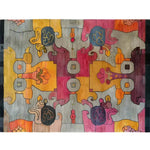 A vibrant interlocking tapestry hand-knotted area rug showcasing an abstract design with bold, contemporary colors. This contemporary rug features an array of geometric and floral patterns in shades of orange, pink, blue, and grey. Ideal as an area rug for living rooms, it adds a splash of color and modern style to any space.