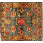 Intricate Bloom Wool Hand Knotted Area Rug featuring a vibrant floral pattern in rich tones of red, yellow, and green. This vintage-inspired square area rug is perfect for adding a touch of elegance to your bedroom or living room. Made from high-quality wool, it resembles classic Persian rugs, making it an ideal choice for those seeking exquisite area rugs for living room decor.