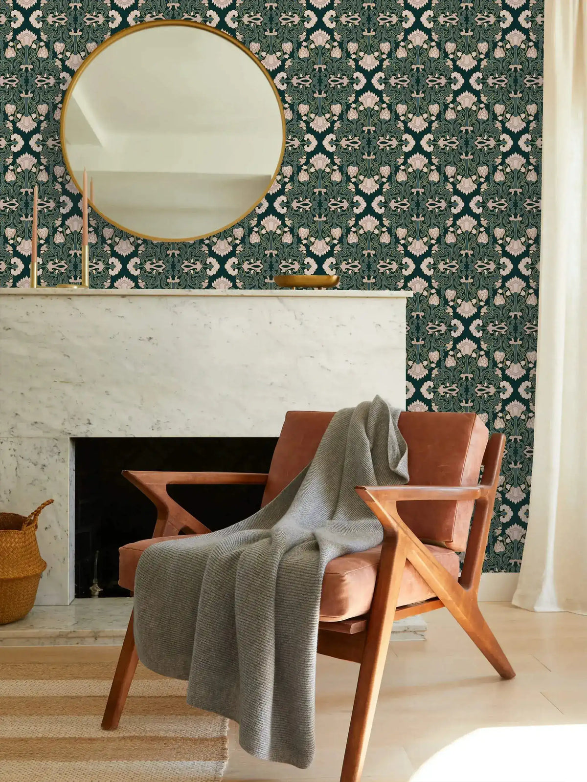 Intricate floral block print wallpaper, cream blooms on teal above a marble fireplace and round mirror