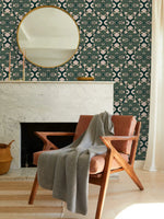 Intricate floral block print wallpaper, cream blooms on teal above a marble fireplace and round mirror