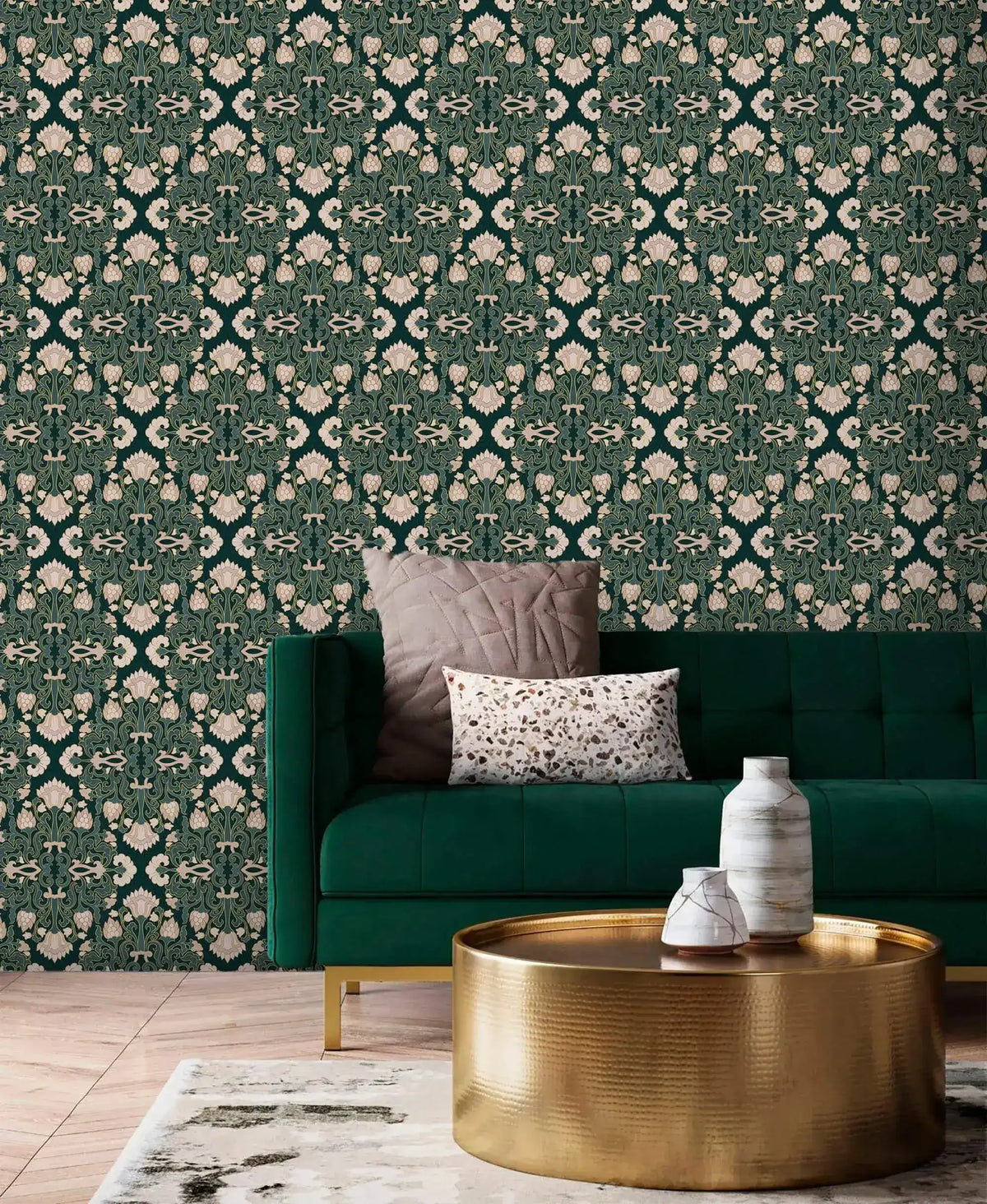 Intricate floral block print wallpaper, cream damask blooms on deep teal behind an emerald velvet sofa