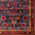 Beautifully detailed area rug featuring an intricate floral pattern in rich reds and oranges on a deep, muted background, perfect for adding a vintage touch to large living room spaces. This hand-tufted wool rug combines elegance and comfort, ideal for enhancing any living room decor.