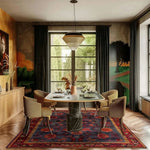 A beautifully designed living room area featuring an intricate pattern hand-tufted area rug with a vintage floral design. The large wool rug adds warmth and texture to the space, complementing the elegant dining setup and large windows that let in natural light.