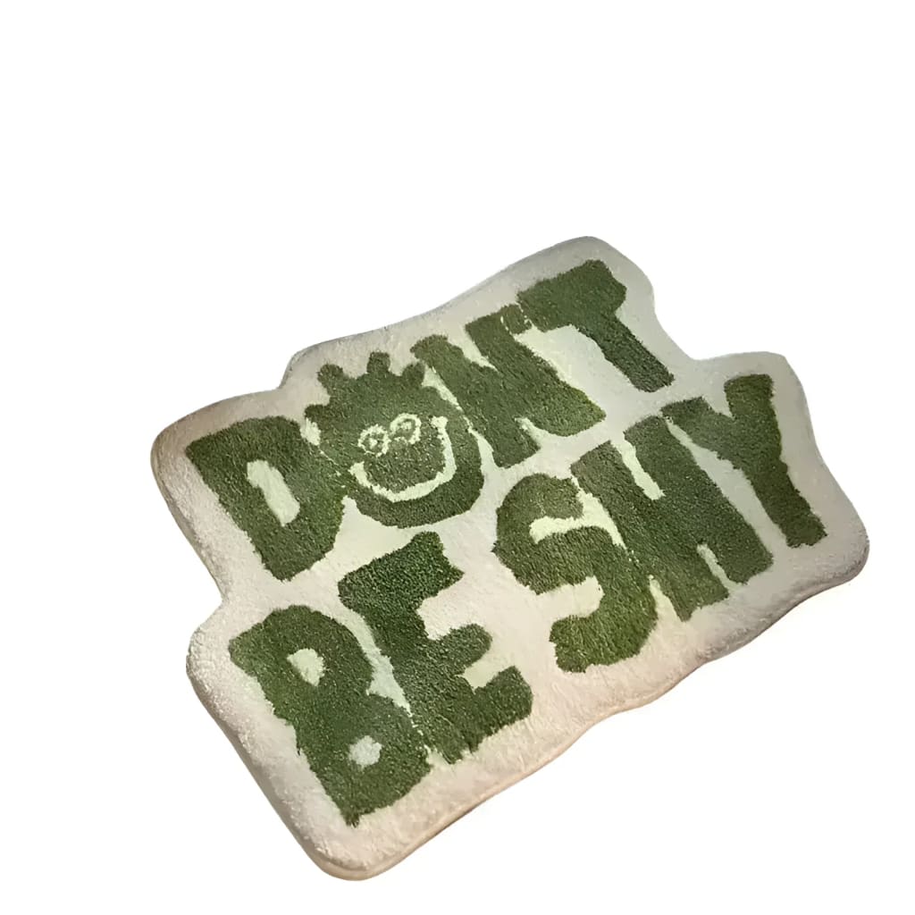 A whimsical area rug with the phrase 'Don't Be Shy' in bold green letters, perfect for adding a playful touch to living room area rugs. This irregularly shaped rug features a unique design that stands out in any space, making it an ideal choice for area rugs for living room decor.