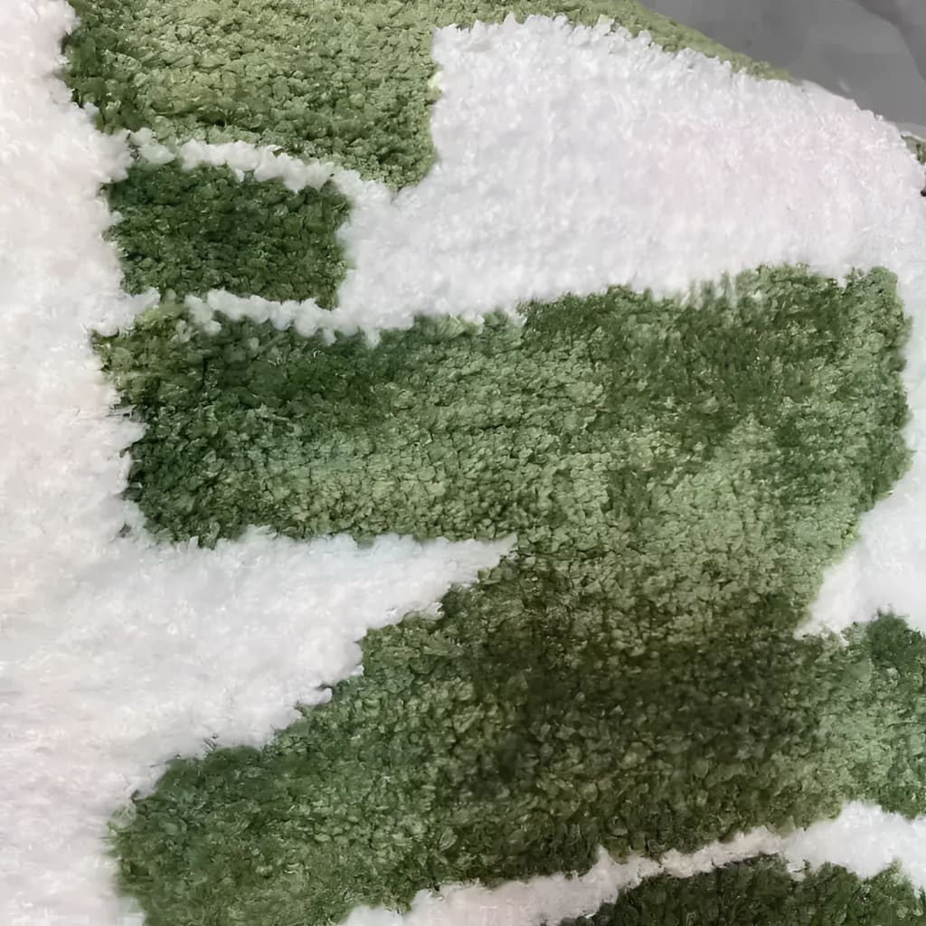 Close-up view of the Irregular 'Don't Be Shy' Area Rug, showcasing its unique green and white abstract pattern. Perfect for adding a modern touch to living room area rugs, this rug exemplifies stylish area rugs for living room decor.