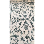 This image showcases the intricate design of the Ivory Whispers Hand Tufted Area Rug. Ideal for large living rooms, this 8x10 wool rug features a vintage-inspired floral pattern in soft ivory tones, perfect for adding a touch of elegance and comfort to your space.