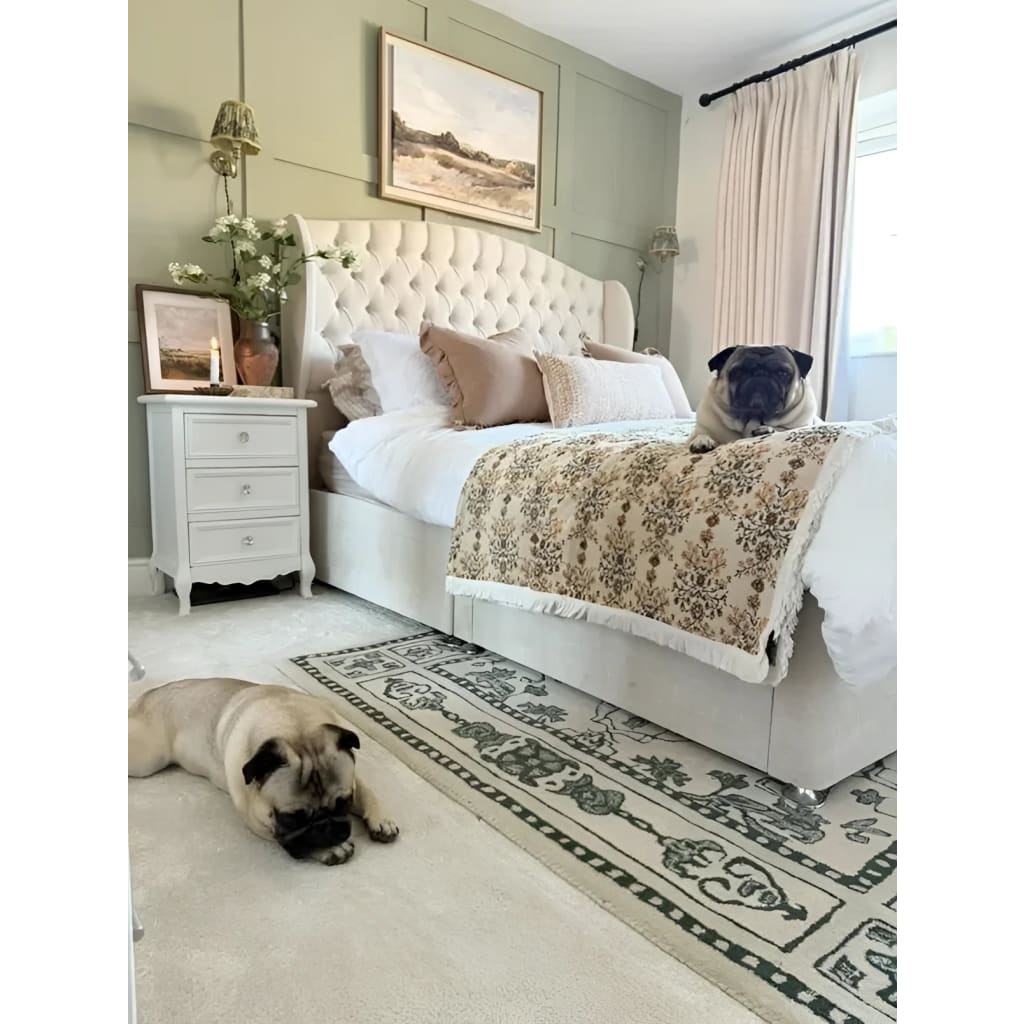 A cozy bedroom featuring a vintage-inspired wool rug beside a plush bed. The area rug, perfect for a large living room setting, adds a touch of elegance with its intricate design, making it ideal for those seeking living room rugs 8x10.