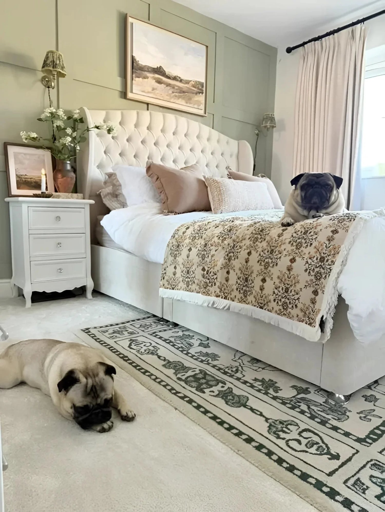 A cozy bedroom featuring a vintage-inspired wool rug beside a plush bed. The area rug, perfect for a large living room setting, adds a touch of elegance with its intricate design, making it ideal for those seeking living room rugs 8x10.