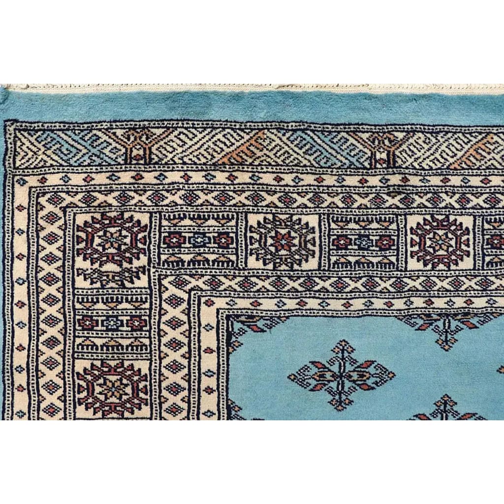 Close-up view of the Javarak Blue Hand Knotted Area Rug, showcasing intricate patterns and vibrant colors ideal for large living room spaces. This detailed design makes it a standout choice among area rugs for living rooms.