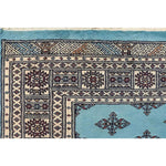 Close-up view of the Javarak Blue Hand Knotted Area Rug, showcasing intricate patterns and vibrant colors ideal for large living room spaces. This detailed design makes it a standout choice among area rugs for living rooms.