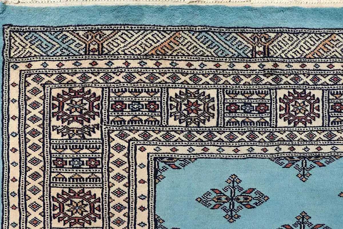 Close-up view of the Javarak Blue Hand Knotted Area Rug, showcasing intricate patterns and vibrant colors ideal for large living room spaces. This detailed design makes it a standout choice among area rugs for living rooms.